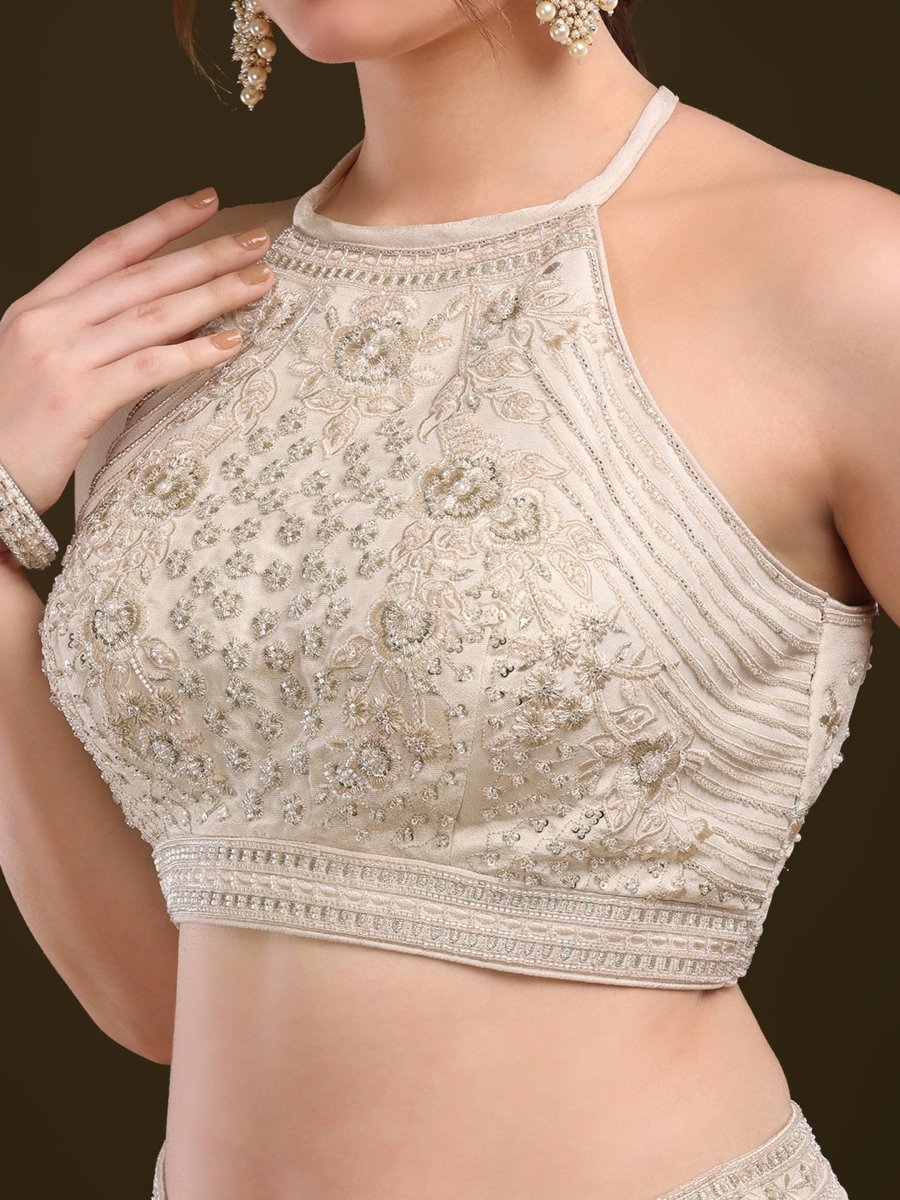 Detailed close-up of sequin and bead embellishment on rust blouse