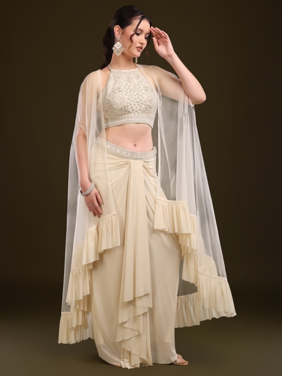 Side profile of rust cape outfit with designer blouse